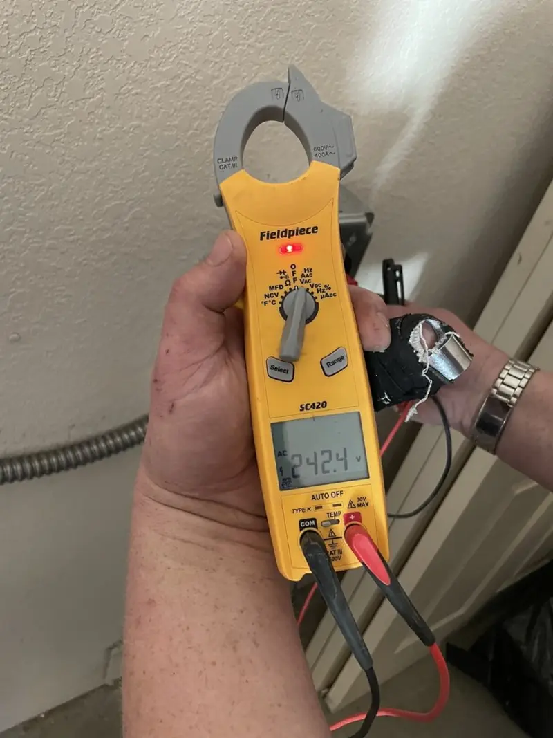 Voltage testing with clamp meter during Outlet Installation in Westwood